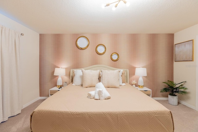 bedroom with light carpet and a textured ceiling