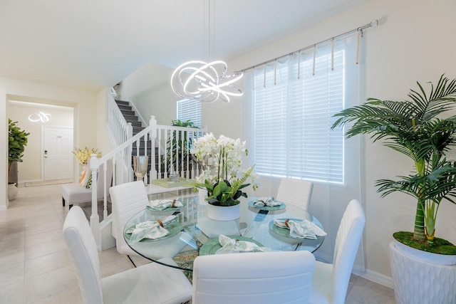 dining room featuring a chandelier and light tile patterned floors