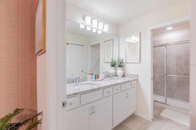 bathroom featuring tile patterned flooring, vanity, and a shower with door