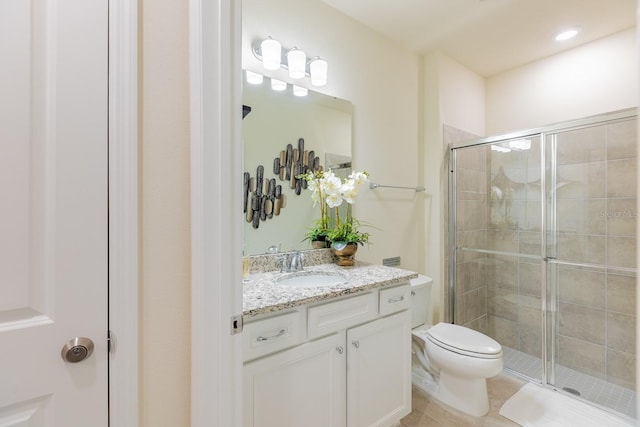 bathroom with tile patterned floors, vanity, toilet, and an enclosed shower