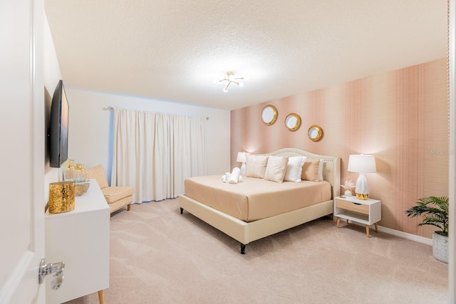 bedroom featuring carpet flooring and a textured ceiling