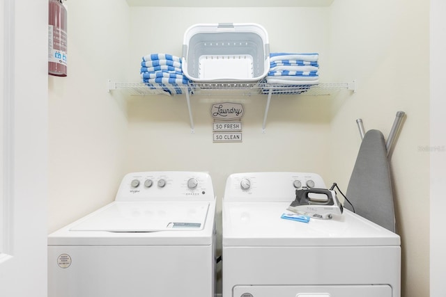 laundry room featuring washing machine and clothes dryer