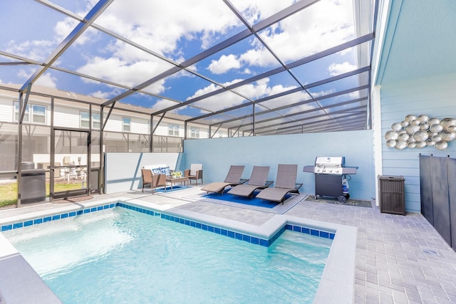 view of swimming pool featuring area for grilling, a patio area, and glass enclosure