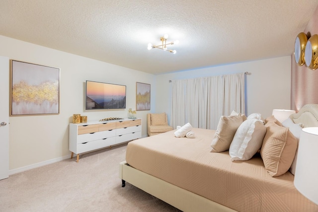 bedroom with light carpet, a textured ceiling, and an inviting chandelier