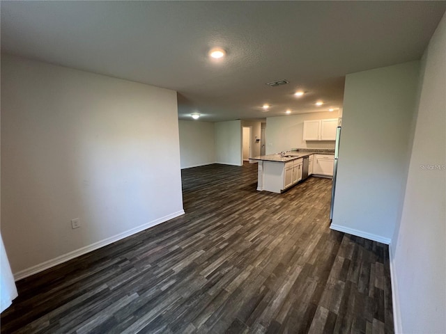 kitchen featuring sink, dishwasher, a center island, dark hardwood / wood-style floors, and white cabinetry