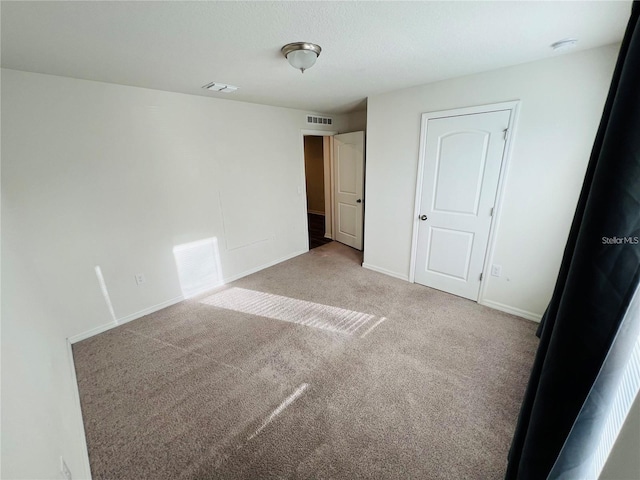 unfurnished bedroom with light carpet