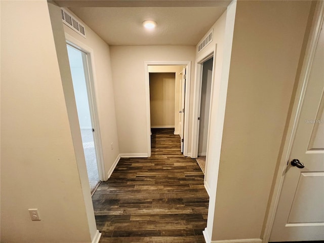 corridor featuring dark hardwood / wood-style flooring