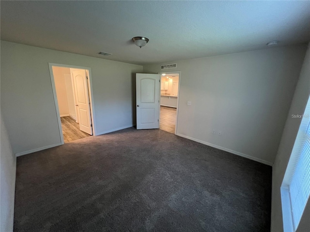 unfurnished bedroom featuring carpet and a closet