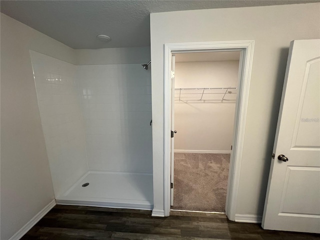 bathroom featuring hardwood / wood-style floors and walk in shower