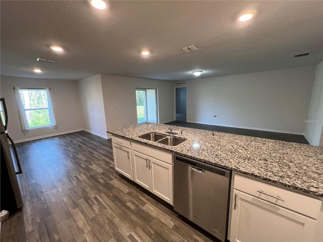 kitchen with white cabinetry, dishwasher, light stone countertops, sink, and dark hardwood / wood-style floors