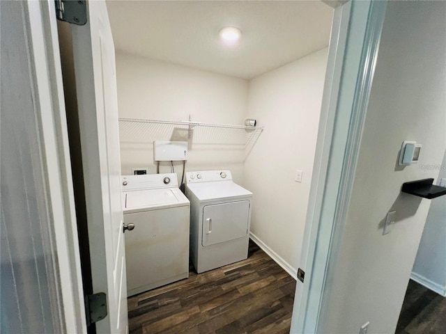 laundry area with washer and clothes dryer and dark wood-type flooring