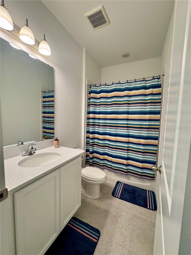 full bathroom featuring shower / bath combination with curtain, vanity, and toilet