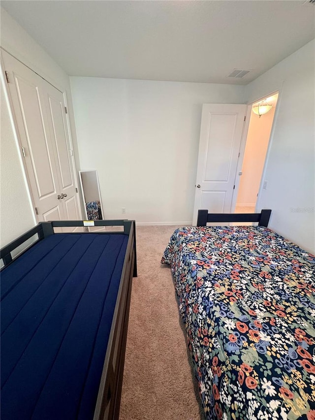 carpeted bedroom with a closet