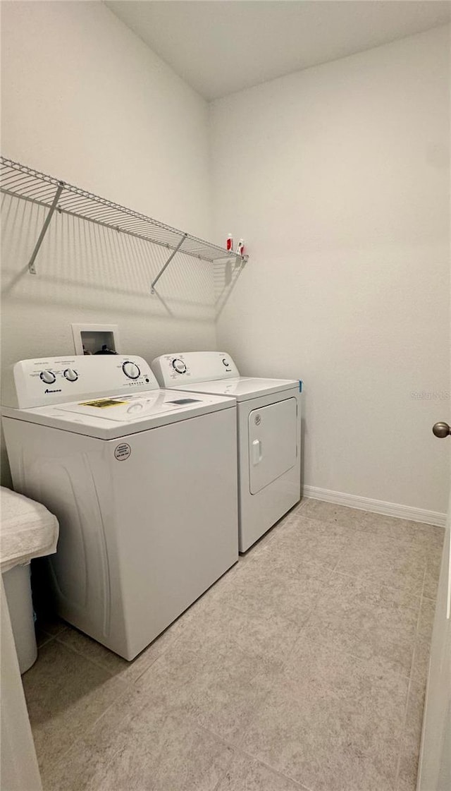 washroom with independent washer and dryer