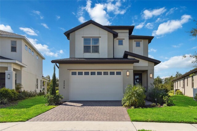 view of front of home with a front lawn and a garage