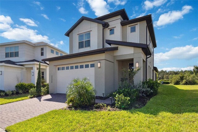 view of front of property featuring a garage and a front yard