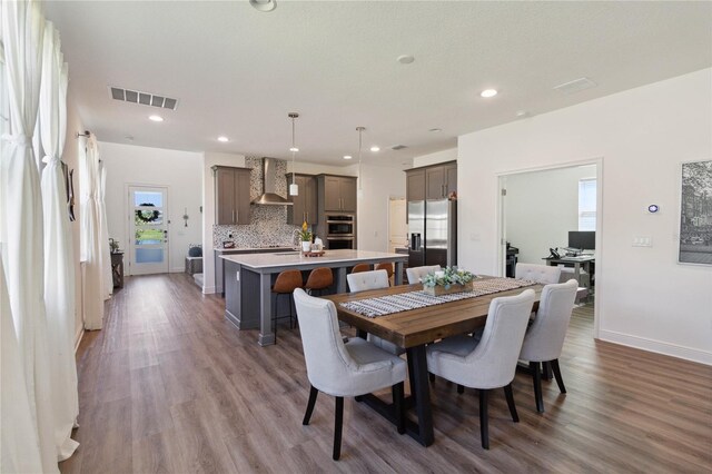 dining space featuring wood-type flooring