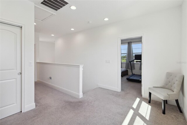 corridor with light colored carpet