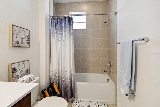 full bathroom featuring shower / bath combo, vanity, and toilet