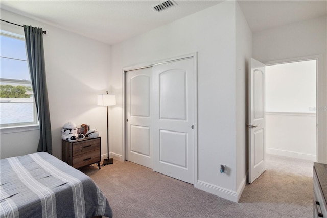 carpeted bedroom with a closet