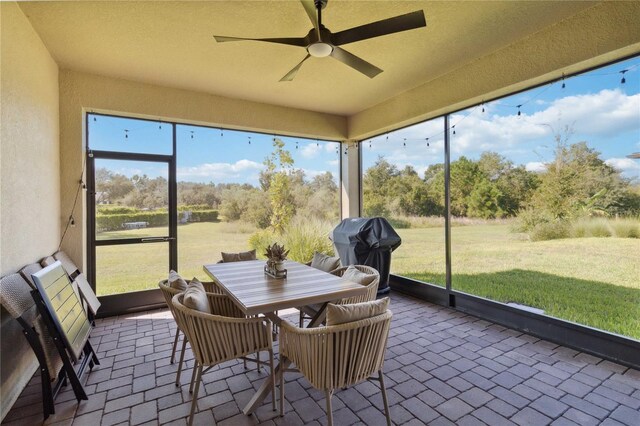 sunroom / solarium featuring ceiling fan