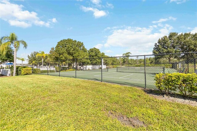 view of sport court featuring a yard