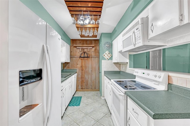 kitchen featuring backsplash, light tile patterned floors, white cabinets, and white appliances