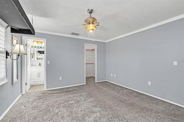 spare room with carpet, ornamental molding, and a wealth of natural light