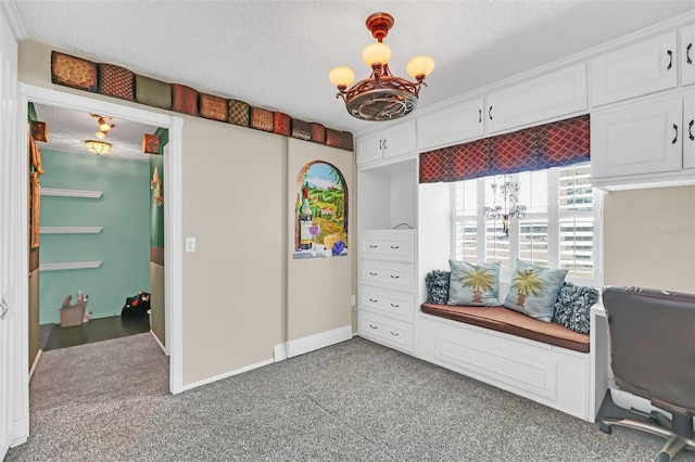 carpeted home office with a notable chandelier and a textured ceiling