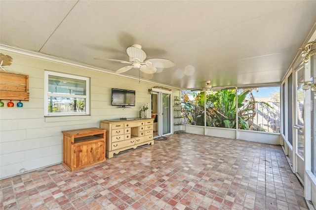 unfurnished sunroom with ceiling fan