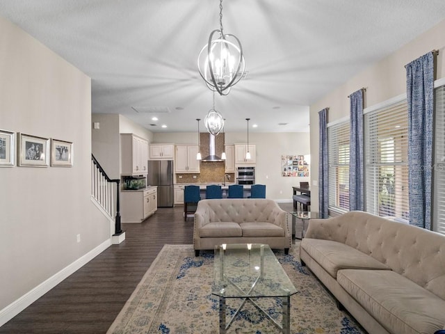 living room featuring dark hardwood / wood-style floors, sink, and an inviting chandelier