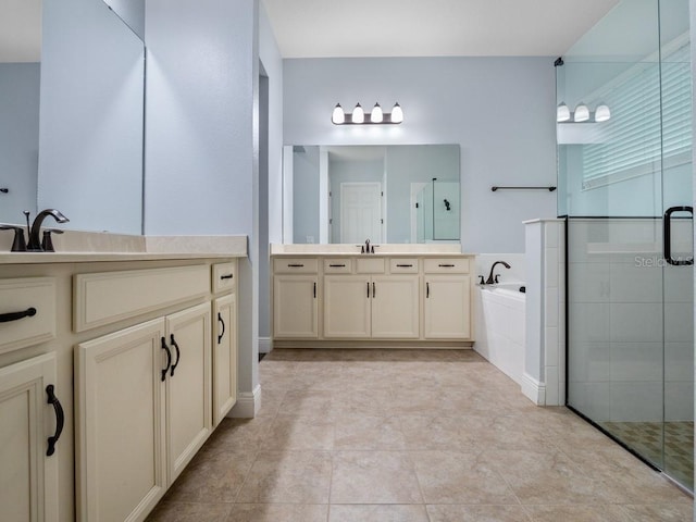 bathroom featuring tile patterned flooring, vanity, and shower with separate bathtub