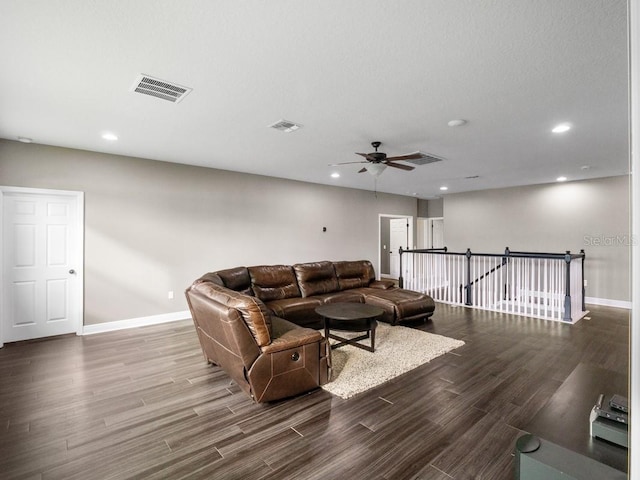 living room featuring dark hardwood / wood-style floors and ceiling fan