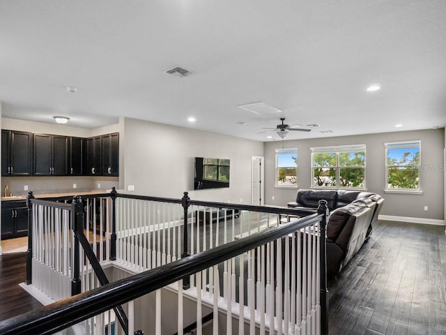 living room with dark hardwood / wood-style floors and ceiling fan