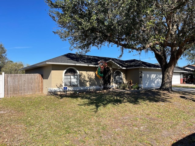 ranch-style house with a garage and a front lawn