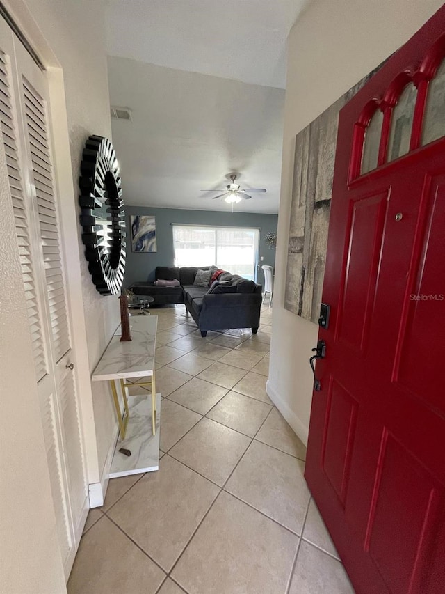 tiled foyer featuring ceiling fan