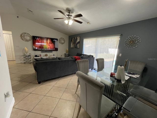 tiled living room with ceiling fan and lofted ceiling