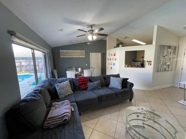 living room featuring ceiling fan, light tile patterned flooring, and vaulted ceiling