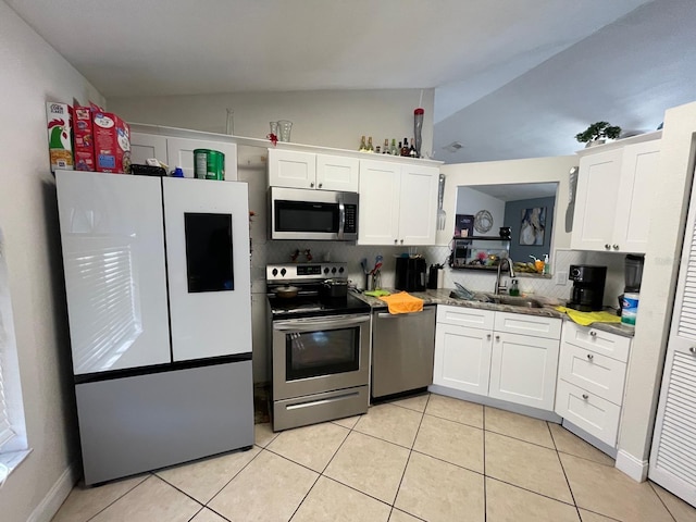 kitchen with sink, white cabinets, lofted ceiling, and appliances with stainless steel finishes