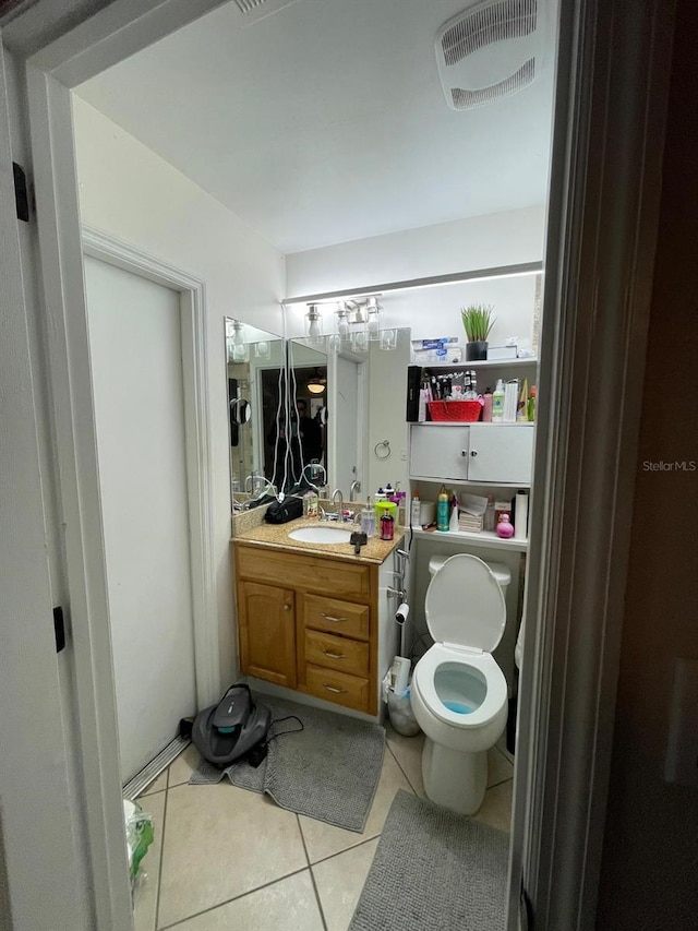 bathroom featuring tile patterned floors, vanity, and toilet