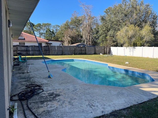 view of swimming pool with a patio area and a lawn