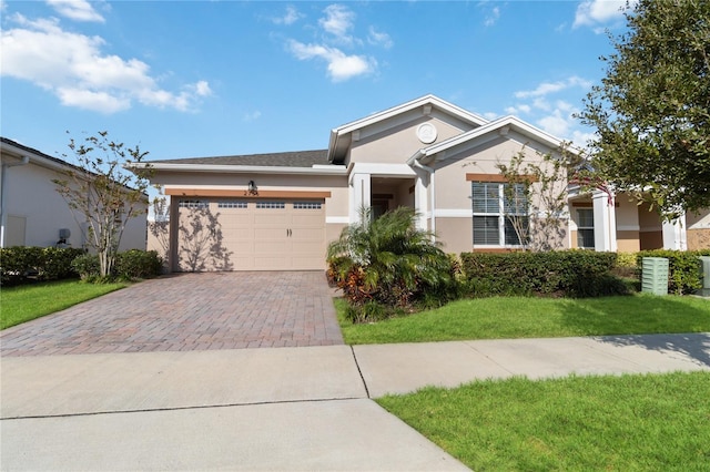 view of front of property with a front lawn and a garage