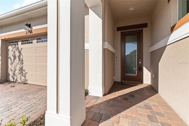 view of exterior entry featuring a garage