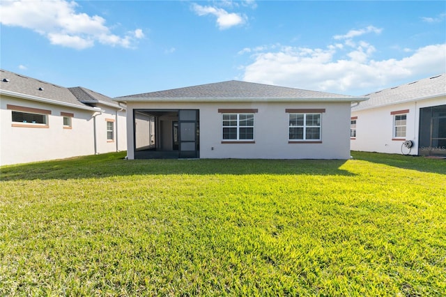 rear view of property with a lawn