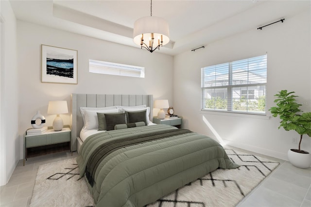 tiled bedroom with a tray ceiling and an inviting chandelier