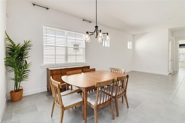 dining room featuring light tile patterned flooring and a chandelier