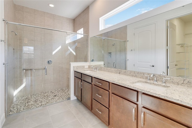 bathroom featuring tile patterned flooring, vanity, and an enclosed shower