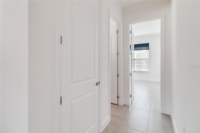 hall with light tile patterned floors