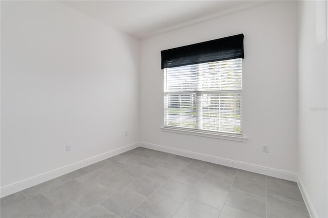 spare room with light tile patterned floors