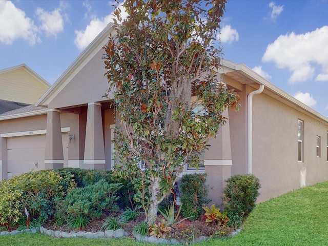 view of side of property with a lawn